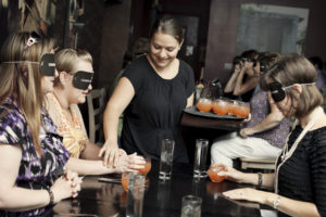 Diners finding their drinks at our IdeaFestival Lights Out Dinner